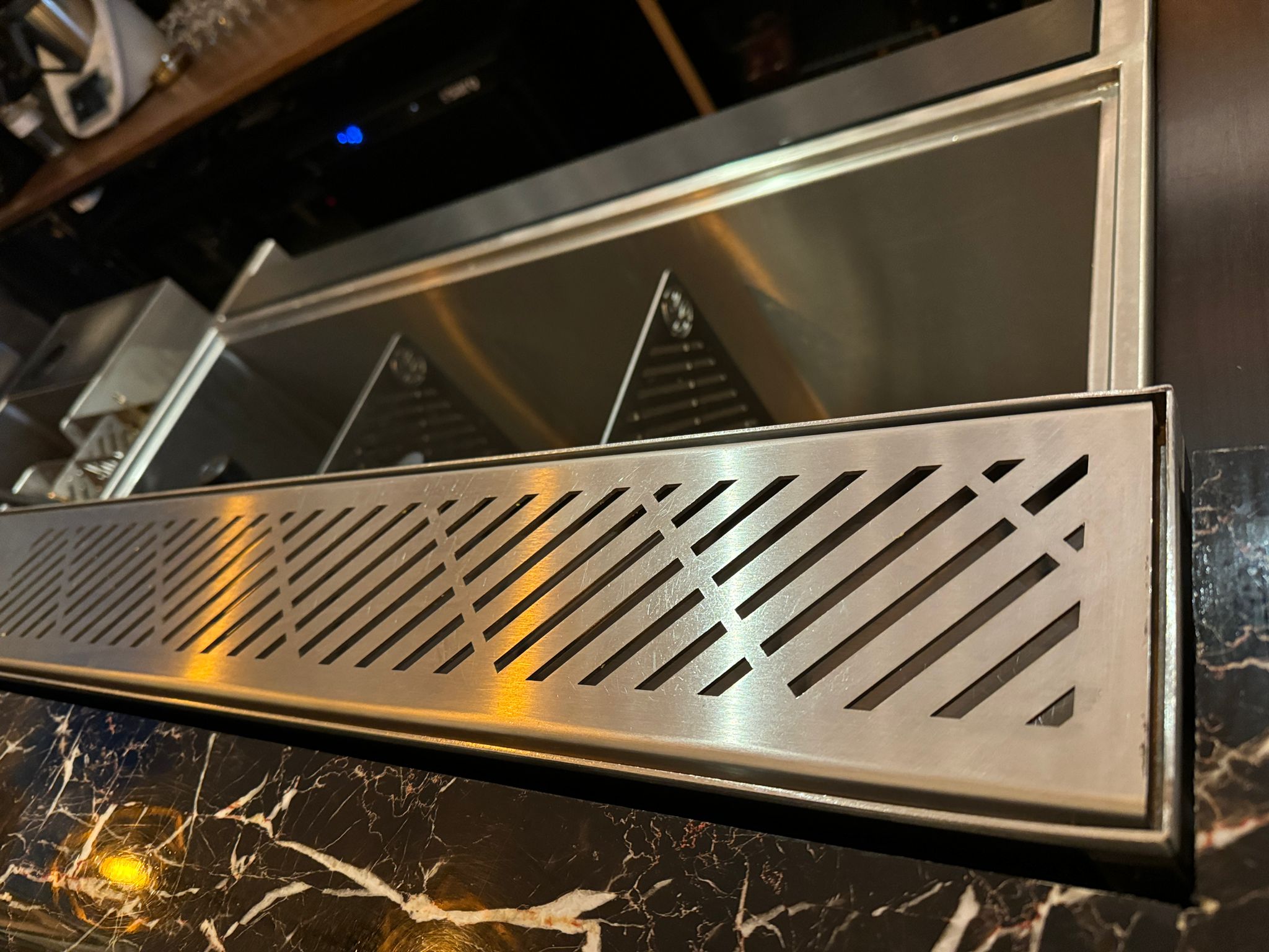 Drink rail drainage system closeup on bar countertop