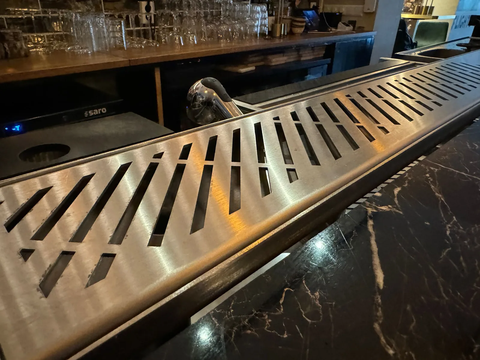 Drink rail installation detail at the bar edge